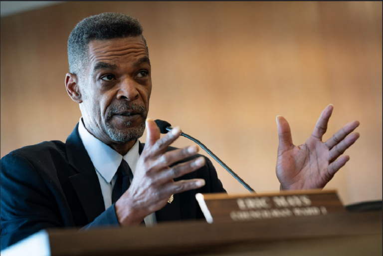 Eric Mays speaking at a council meeting, highlighting his role as a politician and entrepreneur. Learn more about Eric Mays' net worth and career.