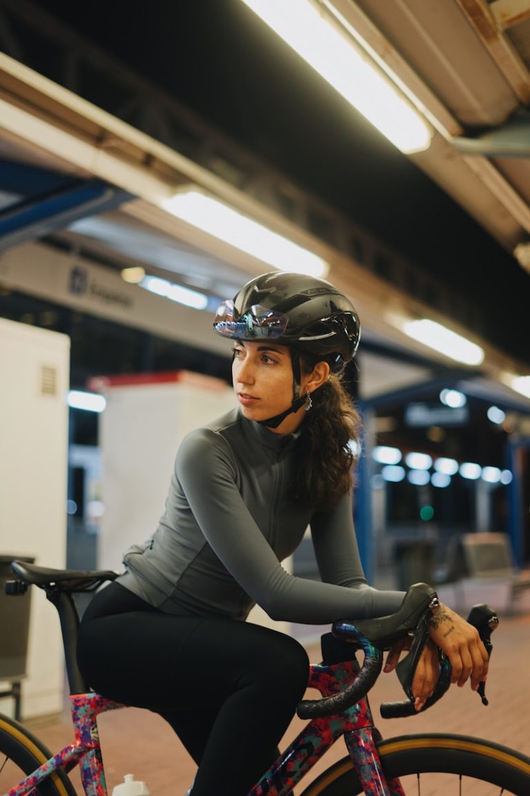 A woman riding a bike in a subway station